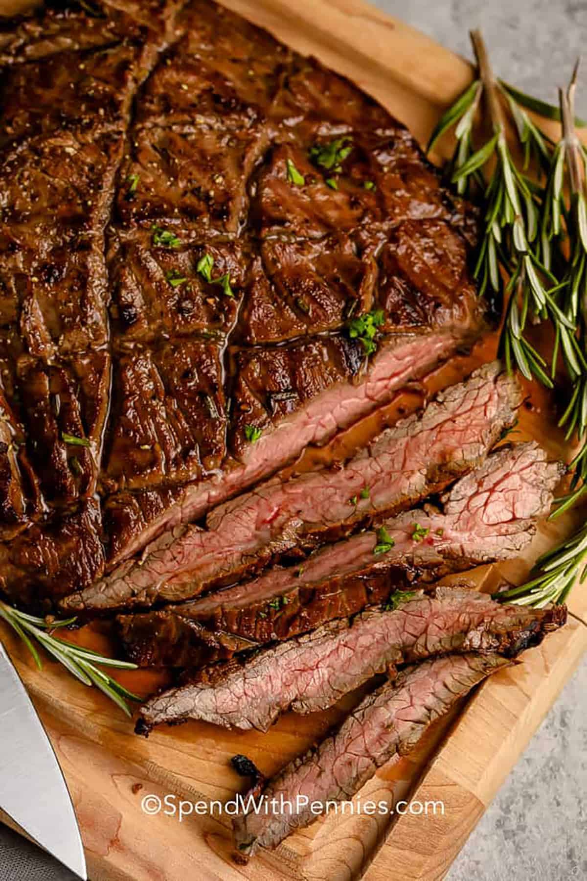 Balsamic Marinated Flank Steak cut on a cutting board