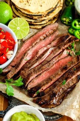 Carne Asada Recipe with ingredients surrounding it
