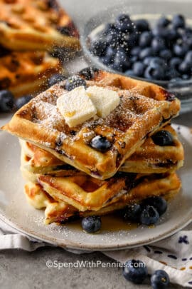Blueberry Waffles on a plate with squares of butter