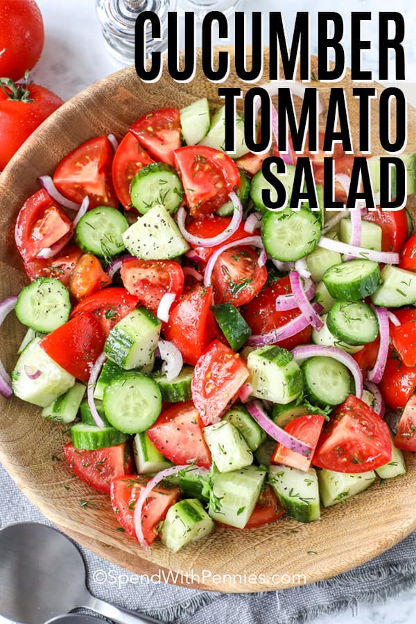 Overhead shot of Cucumber Tomato Salad in a wooden bowl with a title