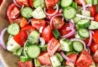 Overhead picture of Cucumber Tomato Salad in a wooden bowl