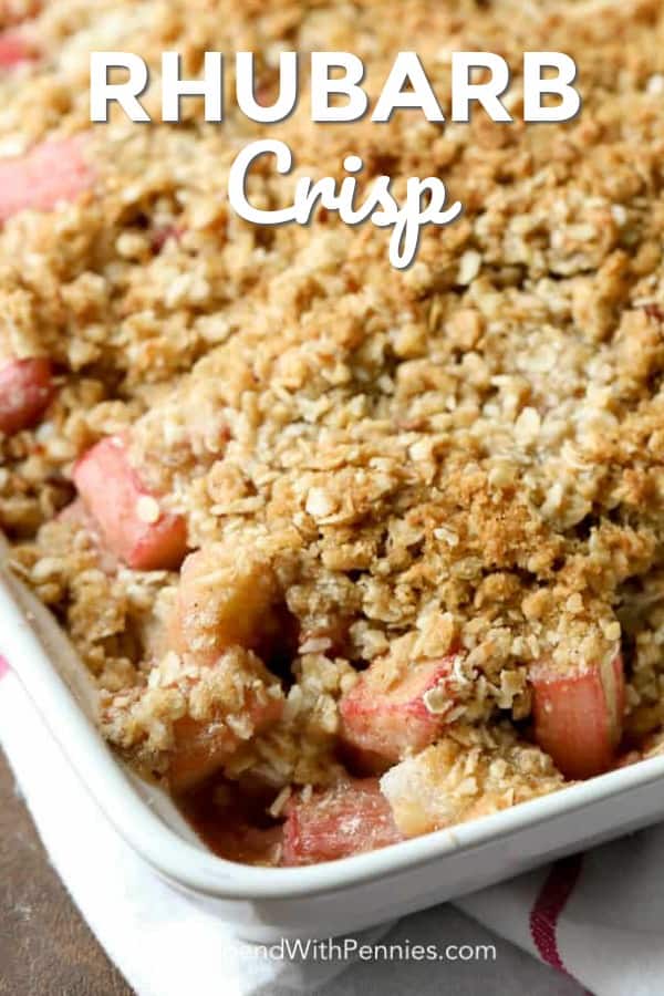 With a perfect balance between sweet and tart, Rhubarb Crisp is a delicious, old fashioned dessert prepared in just minutes! This easy Rhubarb Crisp is a delicious and easy dessert you can make in minutes! With the perfect balance between sweet and tart, rhubarb crisp is going to be your new summer favorite. #spendwithpennies #easyrecipe #easydessert #rhubarbcrisp #strawberryrhubarb #withoatmeal #bakedrecipe #fruitcrisp close up of prepared rhubarb crisp.