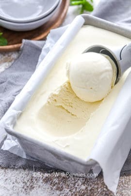 No Churn ice cream in a loaf pan with some being scooped out