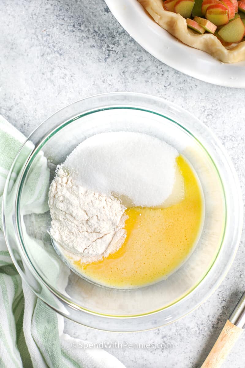 adding ingredients together for custard to make a Rhubarb Custard Pie