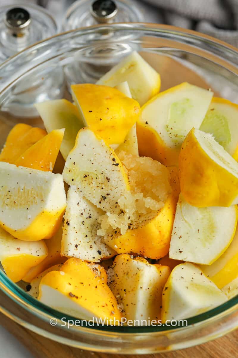 adding seasonings to squash to make Roasted Patty Pan Squash
