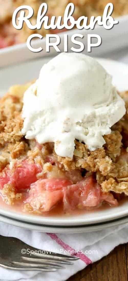 This easy Rhubarb Crisp is a delicious and easy dessert you can make in minutes! With the perfect balance between sweet and tart, rhubarb crisp is going to be a new family favorite! This easy Rhubarb Crisp is a delicious and easy dessert you can make in minutes! With the perfect balance between sweet and tart, rhubarb crisp is going to be your new summer favorite. #spendwithpennies #easyrecipe #easydessert #rhubarbcrisp #strawberryrhubarb #withoatmeal #bakedrecipe #fruitcrisp Rhubarb Crisp served on a white plate with ice cream on top