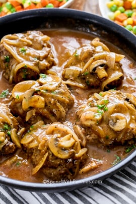 salisbury steak with mushroom gravy cooked in a skillet