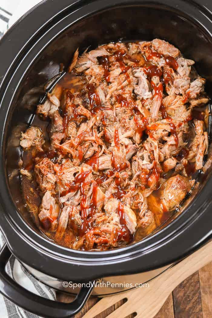 Overhead shot of pulled pork in a black slow cooker