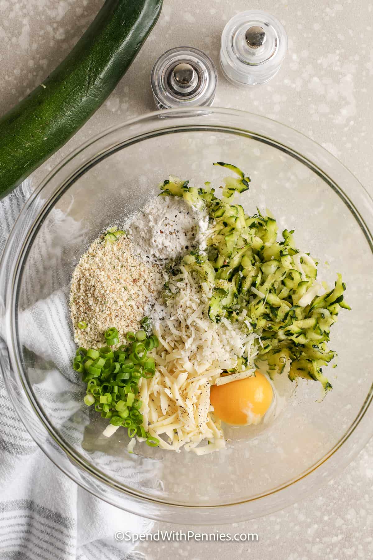 ingredients for zucchini fritters in a bowl