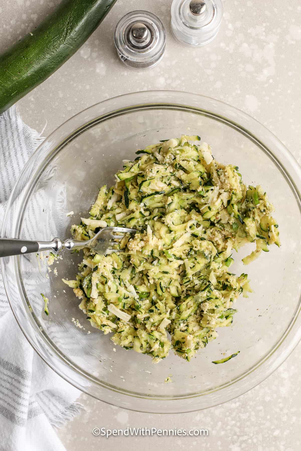 mixed ingredients for zucchini fritters in a bowl